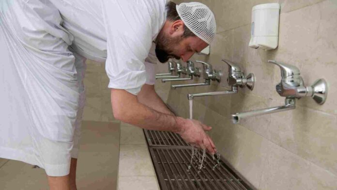 Man washing hands during wudu for prayer
